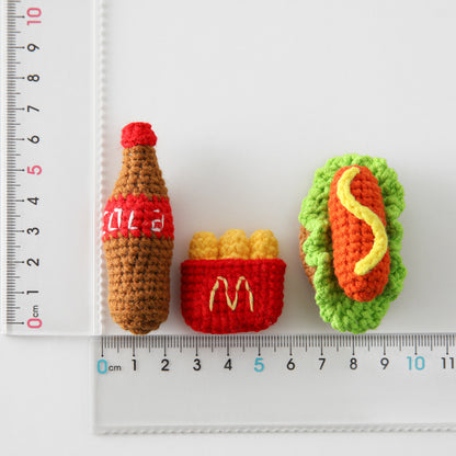 Crocheted meal pendant, small hamburger, chicken legs, French fries, and cola