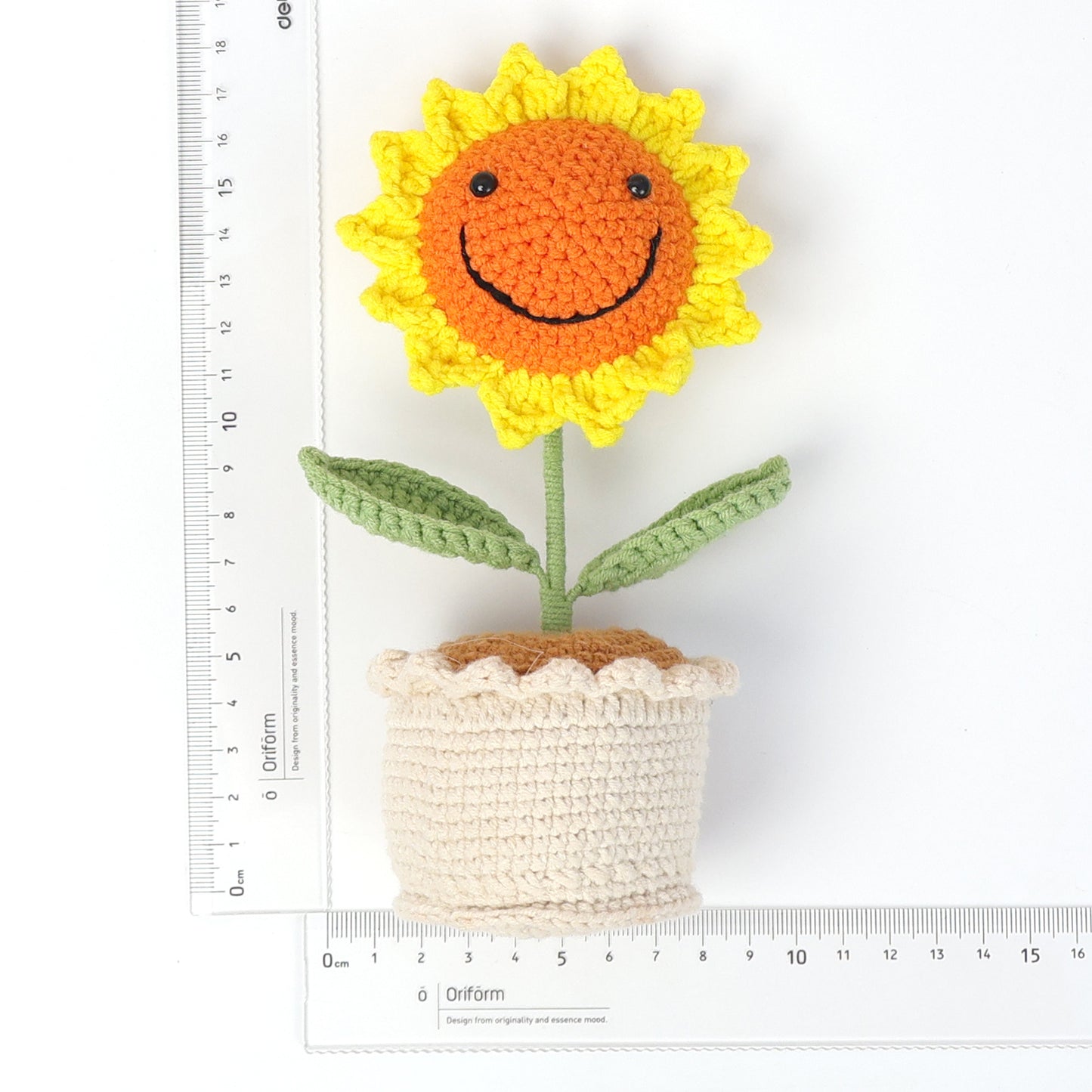 Handmade crocheted sunflower potted plant with smiling face