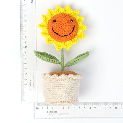 Handmade crocheted sunflower potted plant with smiling face